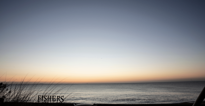 Fishers sign against the coastline