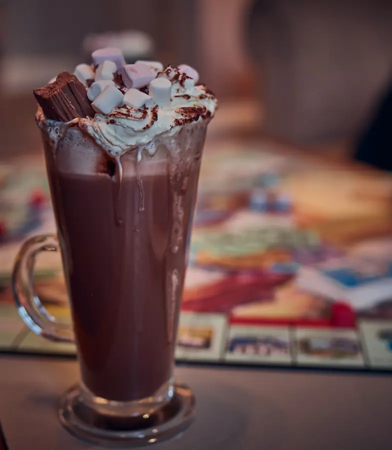 The White Lion hot chocolate in a glass with cream and marshmallows on top
